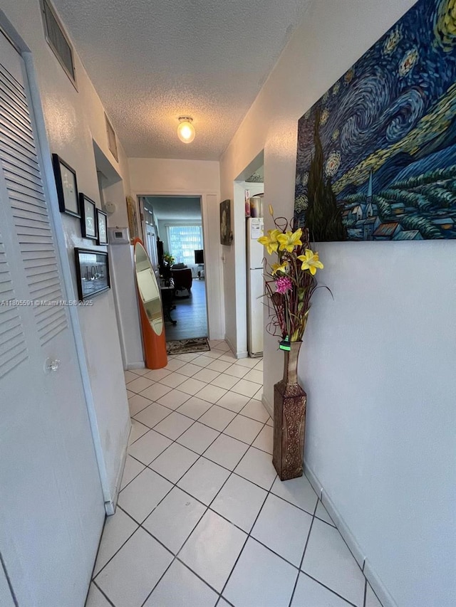 7400 NW 17th St Unit 209, Plantation, FL 33313 - corridor with a textured ceiling and light tile patterned flooring