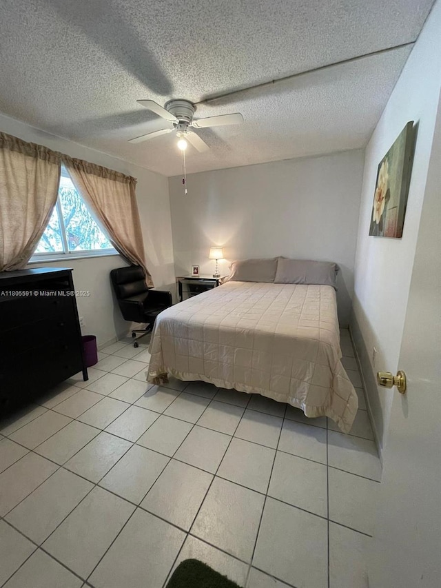 7400 NW 17th St Unit 209, Plantation, FL 33313 - bedroom with light tile patterned floors, a textured ceiling, and a ceiling fan