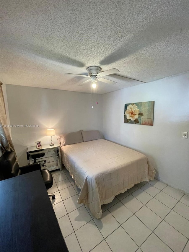 7400 NW 17th St Unit 209, Plantation, FL 33313 - bedroom featuring light tile patterned flooring, a ceiling fan, and a textured ceiling