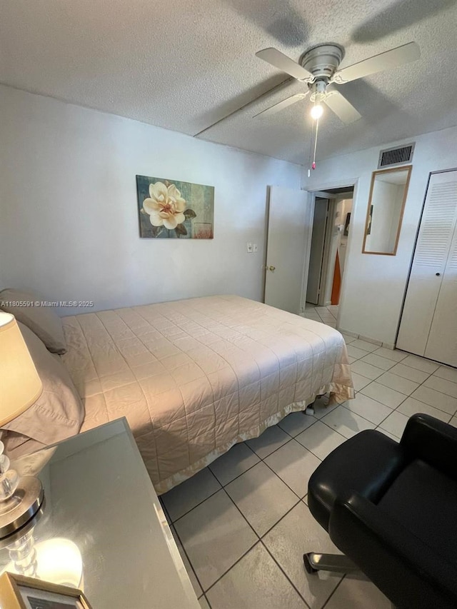 7400 NW 17th St Unit 209, Plantation, FL 33313 - bedroom featuring a textured ceiling, light tile patterned flooring, and ceiling fan
