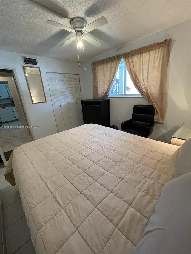 7400 NW 17th St Unit 209, Plantation, FL 33313 - bedroom with a textured ceiling, a closet, and a ceiling fan