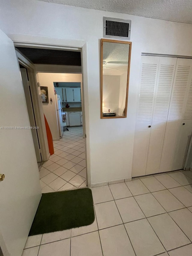 7400 NW 17th St Unit 209, Plantation, FL 33313 - hallway with light tile patterned floors and a textured ceiling