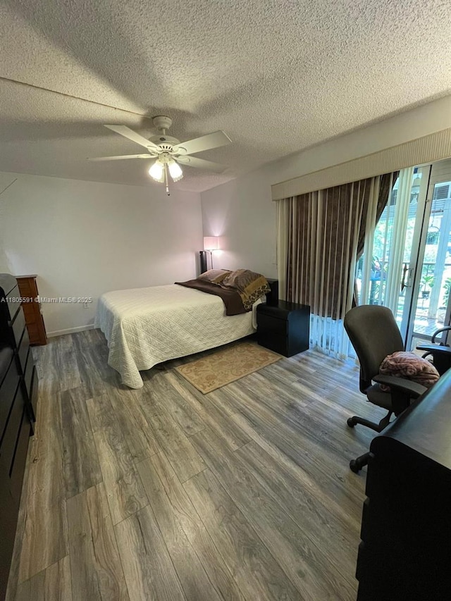 7400 NW 17th St Unit 209, Plantation, FL 33313 - bedroom with wood finished floors, a textured ceiling, and a ceiling fan