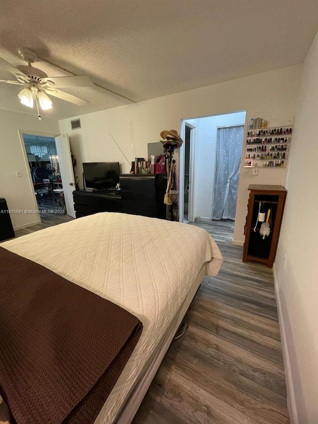 7400 NW 17th St Unit 209, Plantation, FL 33313 - bedroom with dark wood-style floors, baseboards, ceiling fan, and a textured ceiling