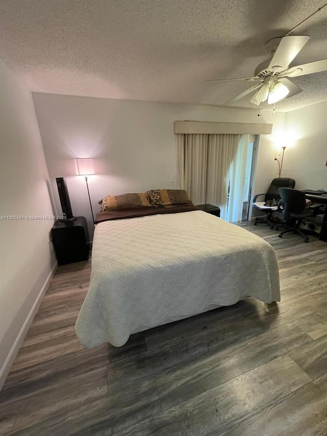 7400 NW 17th St Unit 209, Plantation, FL 33313 - bedroom with a textured ceiling, wood finished floors, baseboards, and ceiling fan