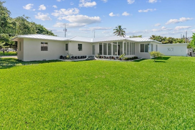 1459 Jefferson St, Hollywood, FL 33020 - back of property featuring a standing seam roof, a lawn, and metal roof