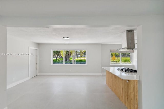1459 Jefferson St, Hollywood, FL 33020 - kitchen featuring stainless steel gas cooktop, island exhaust hood, plenty of natural light, and baseboards