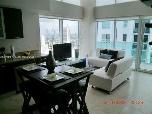 41 SE 5th St Unit 2317, Miami, FL 33131 - living room with healthy amount of natural light and light tile patterned floors