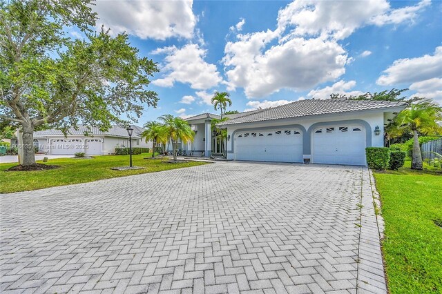 5362 NW 108th Way, Coral Springs, FL 33076 - single story home with decorative driveway, stucco siding, a front yard, an attached garage, and a tile roof