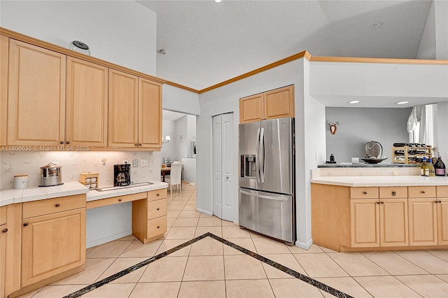 5362 NW 108th Way, Coral Springs, FL 33076 - kitchen featuring stainless steel fridge with ice dispenser, light brown cabinetry, vaulted ceiling, tile counters, and crown molding
