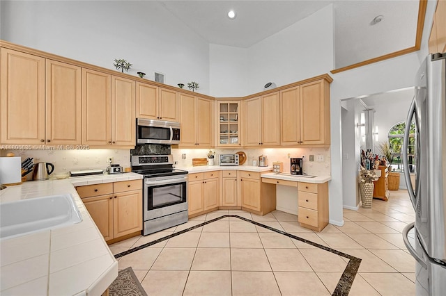 5362 NW 108th Way, Coral Springs, FL 33076 - kitchen featuring stainless steel appliances, light brown cabinets, tile countertops, a sink, and a high ceiling