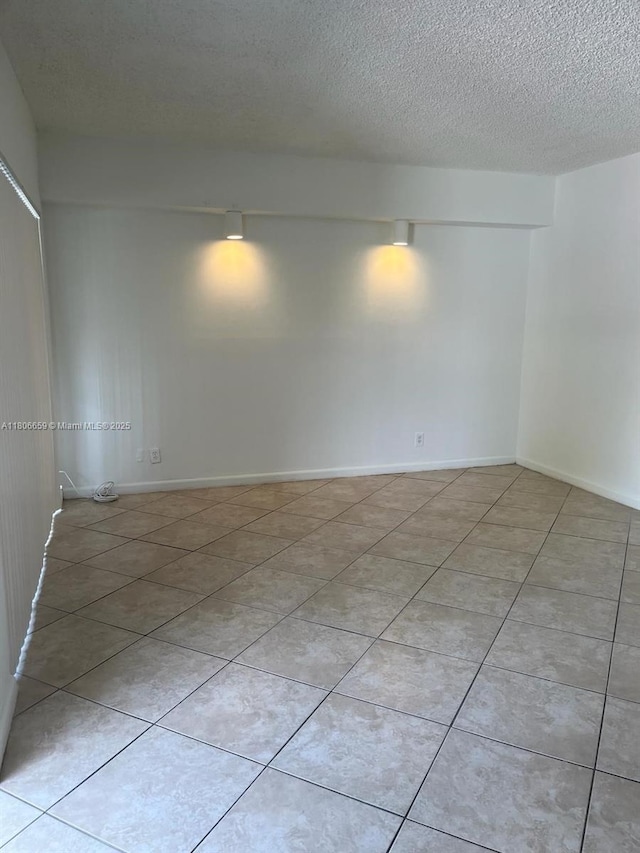 4017 N University Dr Unit 210, Sunrise, FL 33351 - empty room with light tile patterned floors and a textured ceiling