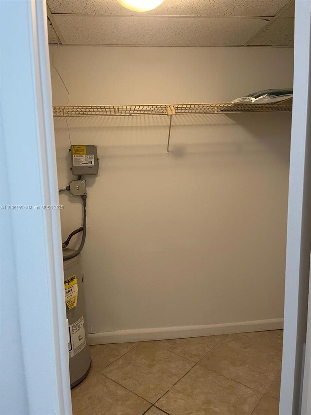 4017 N University Dr Unit 210, Sunrise, FL 33351 - spacious closet with water heater, light tile patterned floors, and a drop ceiling