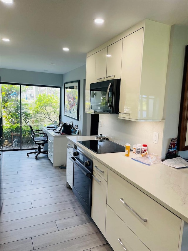 7736 Lakeside Blvd Unit G205, Boca Raton, FL 33434 - kitchen featuring black appliances, recessed lighting, white cabinets, modern cabinets, and light countertops