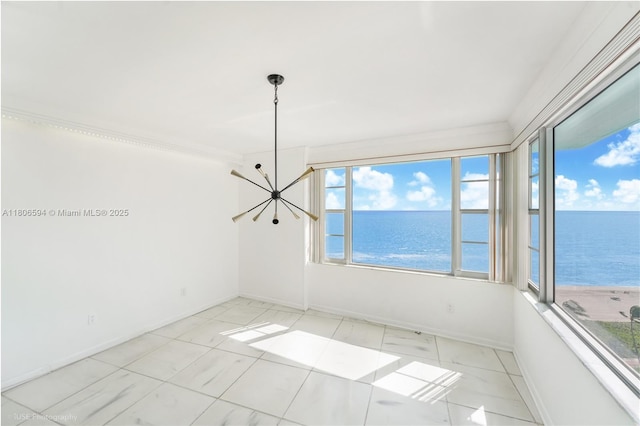 5255 Collins Ave Unit 14D, Miami Beach, FL 33140 - empty room with a water view, baseboards, a chandelier, and ornamental molding