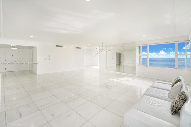 5255 Collins Ave Unit 14D, Miami Beach, FL 33140 - unfurnished living room with a water view, recessed lighting, and a chandelier