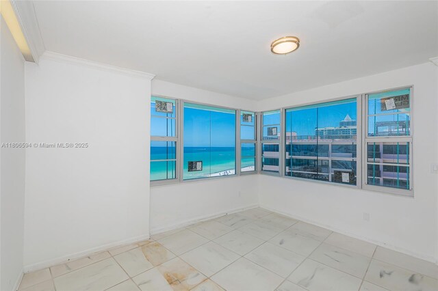 5255 Collins Ave Unit 14D, Miami Beach, FL 33140 - spare room with crown molding and baseboards