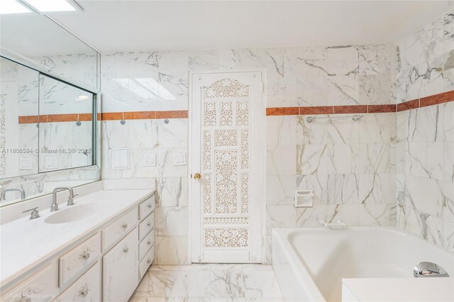 5255 Collins Ave Unit 14D, Miami Beach, FL 33140 - full bath with a tub to relax in, vanity, marble tiled flooring, and tile walls