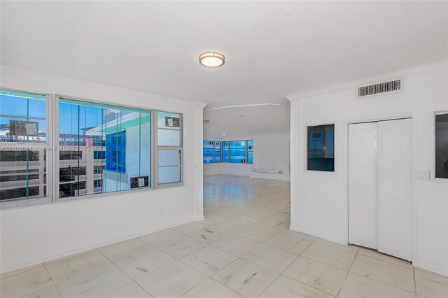 5255 Collins Ave Unit 14D, Miami Beach, FL 33140 - spare room featuring crown molding and ornate columns