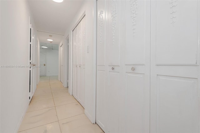 5255 Collins Ave Unit 14D, Miami Beach, FL 33140 - hallway featuring light tile patterned flooring and baseboards