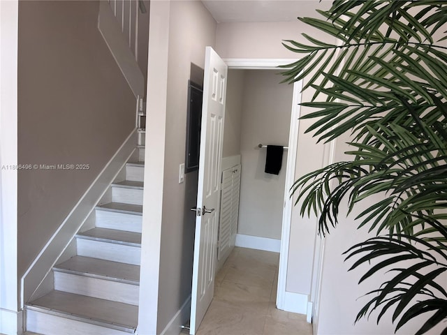 stairway featuring baseboards