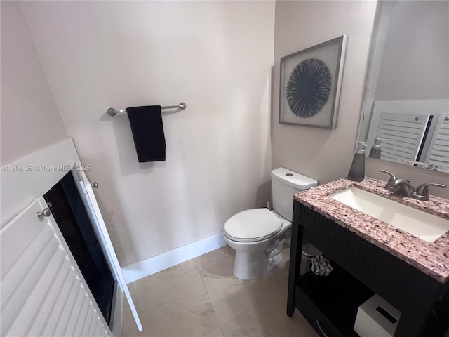 half bath featuring vanity and toilet