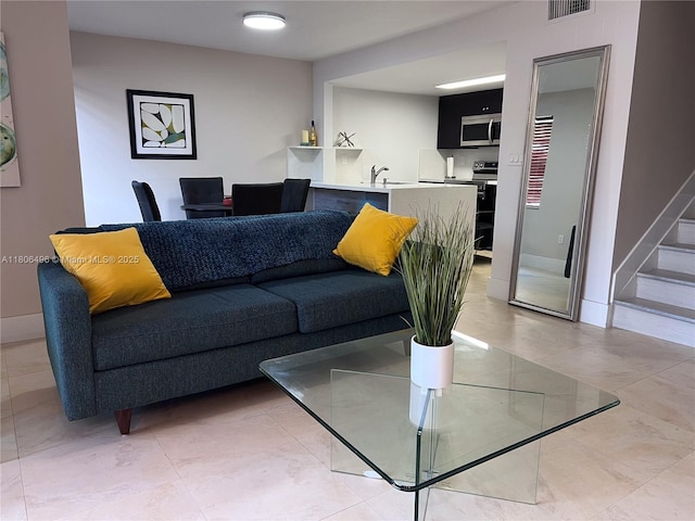 living area featuring stairway