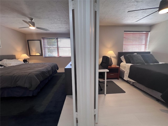 bedroom with a textured ceiling and a ceiling fan