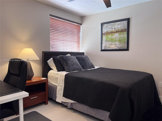 bedroom featuring a textured ceiling and a ceiling fan
