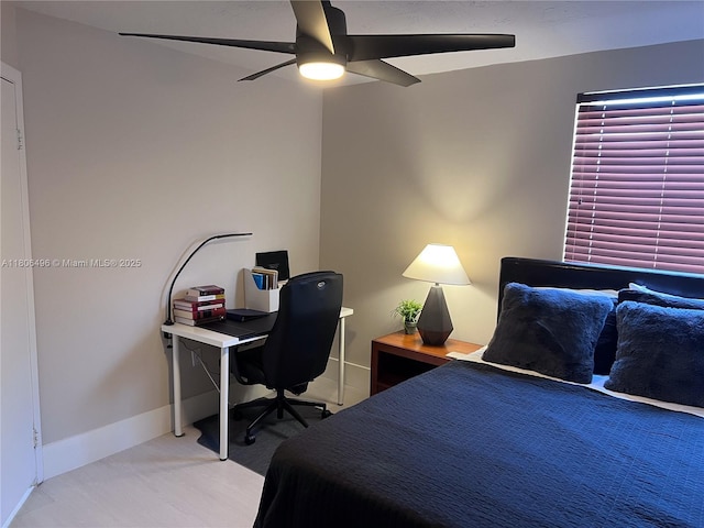 bedroom with baseboards, a ceiling fan, and a desk