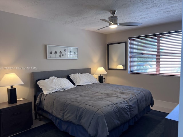 bedroom with a textured ceiling and ceiling fan