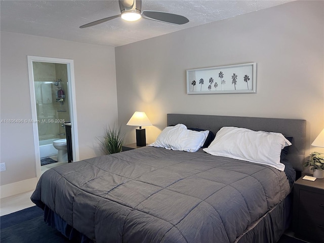 bedroom featuring ensuite bath, a textured ceiling, and ceiling fan