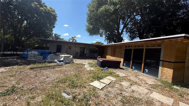 671 NE 140th St, North Miami, FL 33161 - back of house featuring a covered hot tub