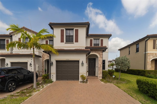 10966 W 33rd Way, Hialeah, FL 33018 - view of front facade featuring a garage, stucco siding, decorative driveway, and a front lawn