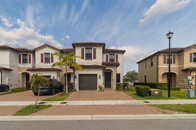 10966 W 33rd Way, Hialeah, FL 33018 - view of front of property with decorative driveway, an attached garage, and stucco siding