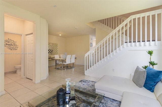10966 W 33rd Way, Hialeah, FL 33018 - living room with tile patterned floors, stairway, and baseboards
