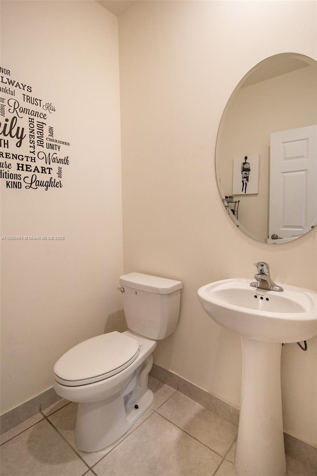10966 W 33rd Way, Hialeah, FL 33018 - half bathroom with toilet, tile patterned flooring, baseboards, and a sink