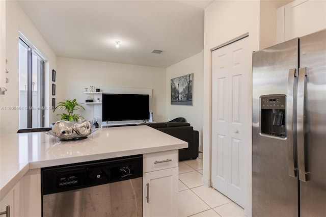10966 W 33rd Way, Hialeah, FL 33018 - kitchen featuring stainless steel appliances, light tile patterned flooring, white cabinetry, light countertops, and open floor plan
