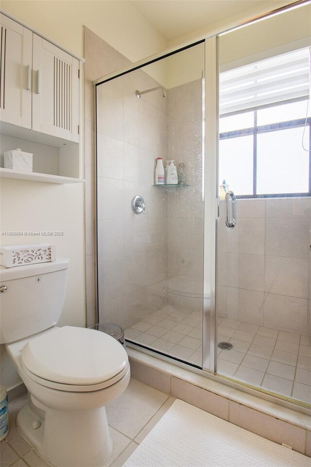 10966 W 33rd Way, Hialeah, FL 33018 - full bathroom with tile patterned floors, toilet, and a stall shower