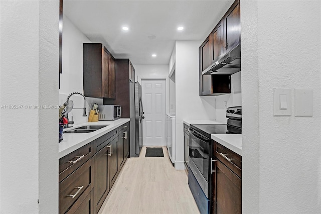 4029 SW 22nd St, West Park, FL 33023 - kitchen featuring stainless steel appliances, under cabinet range hood, light wood-type flooring, a sink, and light countertops