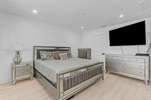 4029 SW 22nd St, West Park, FL 33023 - bedroom featuring light wood finished floors, recessed lighting, and a textured ceiling