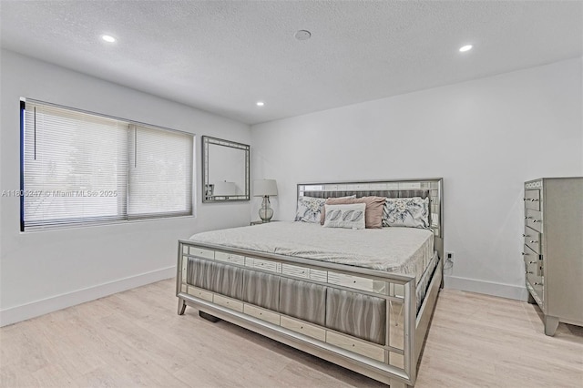4029 SW 22nd St, West Park, FL 33023 - bedroom with light wood finished floors, baseboards, a textured ceiling, and recessed lighting