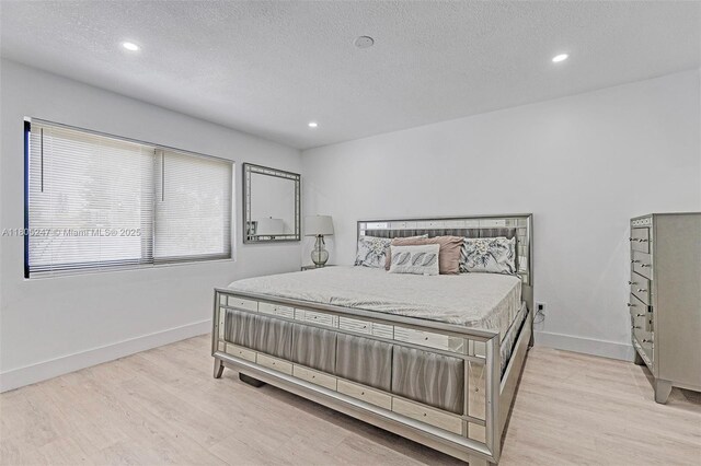 4029 SW 22nd St, West Park, FL 33023 - bedroom featuring light wood-style floors, a textured ceiling, and recessed lighting