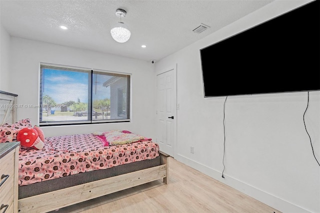 4029 SW 22nd St, West Park, FL 33023 - bedroom featuring light wood finished floors, recessed lighting, and a textured ceiling