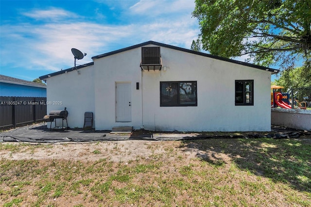 4029 SW 22nd St, West Park, FL 33023 - back of property featuring a playground and stucco siding