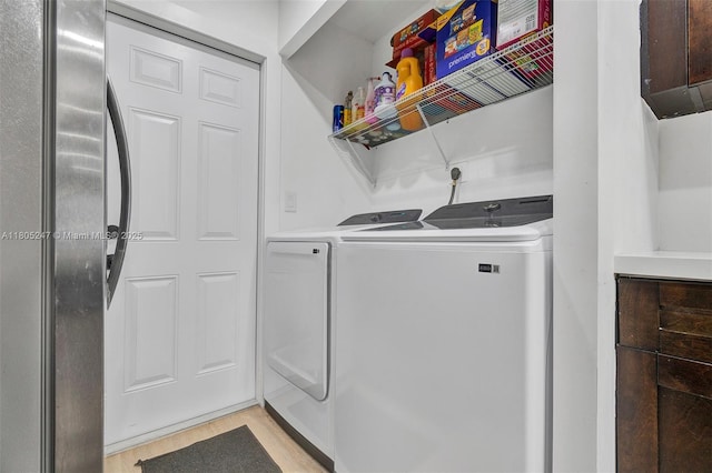 4029 SW 22nd St, West Park, FL 33023 - laundry area with washing machine and clothes dryer and light wood-style floors