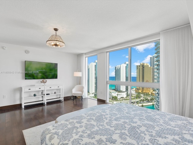 200 Sunny Isles Blvd Unit 2-Uph3, Sunny Isles Beach, FL 33160 - bedroom with hardwood / wood-style flooring, a chandelier, a textured ceiling, and baseboards