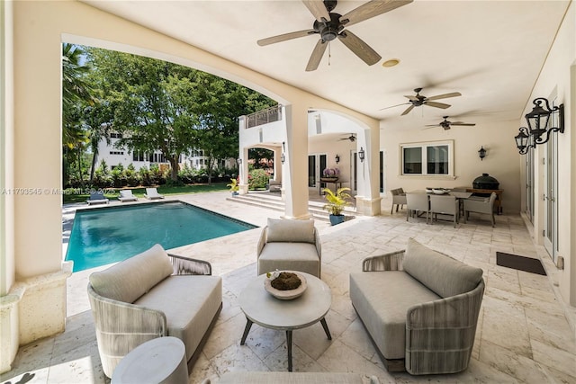 outdoor pool featuring a ceiling fan, an outdoor hangout area, a patio area, and outdoor dining space
