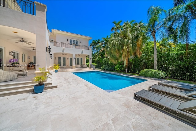 swimming pool featuring ceiling fan, a patio area, french doors, and outdoor lounge area