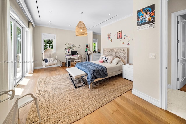 bedroom featuring light wood finished floors, ornamental molding, access to outside, and baseboards